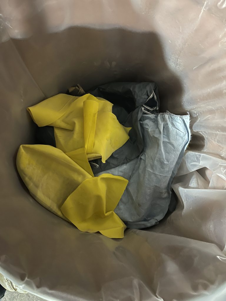 The crew scooped up the solidified product waste and placed it into an additional 55-gallon OTS drum along with their PPE.